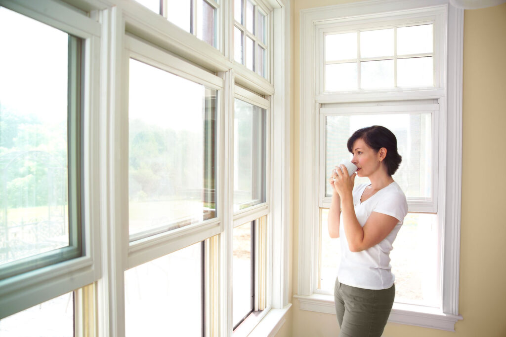 Woman homeowner enjoying a newly installed window in her home